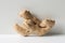 Cute fresh ginger root on white floor and grey wall