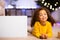 Cute friendly afro little girl resting near awesome Christmas offer