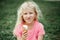 Cute funny adorable girl with dirty nose and milk moustaches eating licking ice cream from waffle cone. Child eating tasty sweet