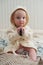 Cute funny baby in bathrobe with phone in her hands