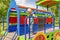 Cute funny blond little young toddler kid child boy standing on colorful train in playground.Children physical,emotional