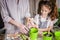 A cute funny girl transplants house plants with her mother. Houseplant care