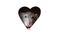 A cute funny rat is looking out of a heart-shaped hole in white paper. The rat is a symbol of the 2020 foot. Copy space