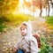 Cute funny toddler in autumn park having fun