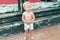 Cute funny upset caucasian 2 year old toddler boy standing abandoned alone at beach summer day. Offended scared child