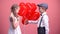 Cute gentleman giving cute girl heart-shaped balloons, Valentines day surprise