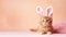 cute ginger kitten with ears bunny, on pink background, Easter concept