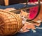 Cute ginger-white kitten looks out from behind the basket. Little cat playing with basket on carpet