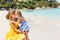 Cute girl and beautiful mother on the beach