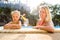 Cute girl and beautiful mother at the pool