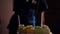 Cute girl blows out candles on a cake on birthday. Happy child looks at a cake with candles. Girl celebrates birthday. Happiness c