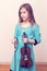 Cute girl in a blue dress with a violin. toned. vertical photo