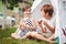 Cute girl and boy eating slices of watermelon at picnic in tent. happy childhood