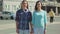 Cute girl and boy with long hair posing on the street time-lapse