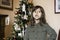 Cute girl child of five or six year old reciting the Christmas poem in the living room in front of the christmas tree - Childhood