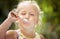 Cute girl child licks a spoon with a delicious ice cream on a co