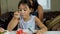 Cute girl eating cake on white dish