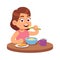 Cute girl eating. Hungry toddler sits at table and eats delicious cereal or muesli with spoon, drinks tea on breakfast