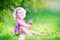 Cute girl eating ice cream in the garden