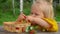 Cute girl eats raspberries from fingers and laughs