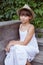 Cute girl in a hat sitting on the porch