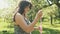 Cute girl have fun with soap bubbles. Young beautiful woman plays in park