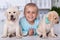 Cute girl with her labrador puppy dogs at the veterinary