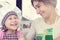 Cute girl with her mother bake cookies at home