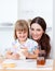 Cute girl and her mother eating slices of bread