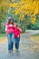 Cute girl with her mother walking in park