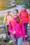 Cute girl with hiking equipment in the mountains