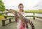 Cute girl holding a crocodile near florida everglades