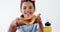Cute girl holding sandwich against white background