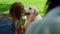 Cute girl hugging labrador on park picnic. Joyful child cuddling dog outdoors