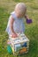 Cute girl inserts figures into the recesses on the development board. Toys for the development of fine motor skills and logic for