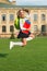 Cute girl jump with notebook. happy preschool girl with book in school yard. back to school. hardworking child carry