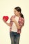 Cute girl in love. Little girl pointing finger at red heart. Little child expressing love on valentines day. Having