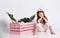 Cute girl next to pink wooden drawer sitting on the floor in a white t-shirt with a Flamingo in the Studio in different poses