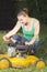 Cute girl oiling and repairing yellow lawn mower