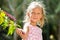 Cute girl picking wild berries.