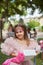 Cute girl in a pink puffy dress in the park