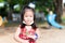 Cute girl played in playground until she was tired. Asian child sweats on the temples. Children smiles sweet. In summer or spring