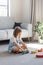 A cute girl is playing an educational game with a wooden rainbow. child development