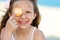 Cute girl playing with shell on beach.