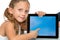 Cute girl pointing on blank tablet screen.