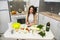 Cute girl prepares a salad of different vegetables and greens for a healthy lifestyle