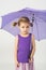A cute girl in a purple clothes with umbrella