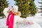 Cute girl ready to throw snowball during day