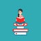 Cute girl with red book siting on stack of books on wide blue background. creative student