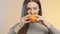 Cute girl rubs halves of an orange with each other, the process of squeezing juice, concept of healthy eating and lifestyle on a s